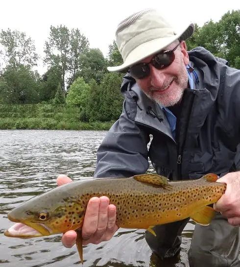 An angler with a big Grand river Brown trout