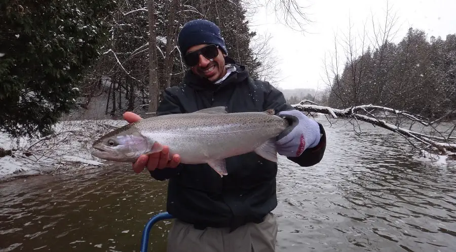 A client on a guided trip with A Perfect Drift Guide company in -10 weather. He is holding 1 of 13 landed that day.