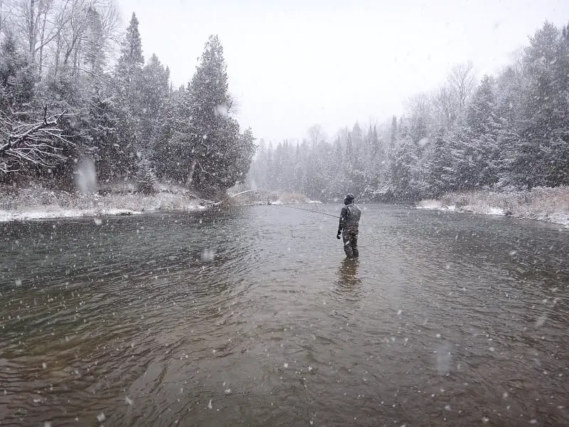 The author winter fishing in a snow storm.